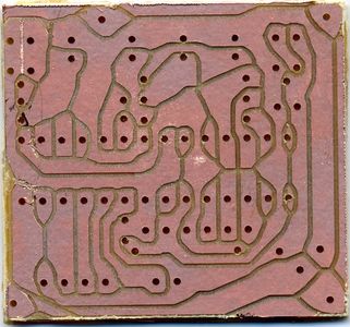 A rather badly isloated and drilled PCB done on the Geilomat. Short circuiting copper flakes are visible on the center left.